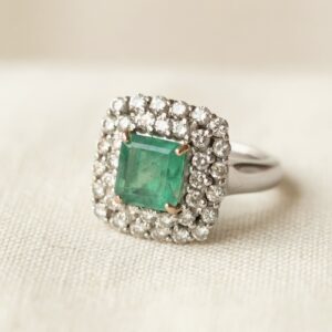 Anillo Oro Blanco con Esmeralda central
